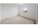 A bright bedroom with neutral carpet, two windows, and light-colored walls at 2736 W 68Th Ave, Denver, CO 80221