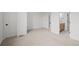 Spacious bedroom featuring neutral carpet and a view into an ensuite bathroom at 2736 W 68Th Ave, Denver, CO 80221