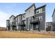 Modern townhome exterior featuring gray siding, black accents, and small balconies at 2736 W 68Th Ave, Denver, CO 80221