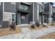 Modern townhome exteriors featuring grey siding, stone accents, and private balconies at 2736 W 68Th Ave, Denver, CO 80221