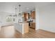 Modern kitchen featuring an island, stainless steel appliances, and wood cabinets at 2736 W 68Th Ave, Denver, CO 80221