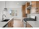Well-equipped kitchen featuring stainless steel appliances, quartz countertops, and wood cabinets at 2736 W 68Th Ave, Denver, CO 80221