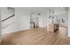 Spacious open floor plan with wood floors, stairway and kitchen with an island at 2736 W 68Th Ave, Denver, CO 80221