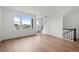 Bright living room with wood floors and large windows with neighborhood view at 2736 W 68Th Ave, Denver, CO 80221