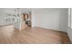 Bright, open-concept living room features light wood floors and a modern kitchen at 2736 W 68Th Ave, Denver, CO 80221