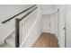 Staircase with wood handrail, carpeted stairs, and modern design at 2736 W 68Th Ave, Denver, CO 80221