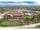 Breathtaking aerial view of a community clubhouse, golf course, pool, tennis courts, and lush landscape at 8255 S Vandriver Way, Aurora, CO 80016