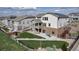 A view of the backyard with a patio and a small deck, showing the outdoor living space at 8255 S Vandriver Way, Aurora, CO 80016