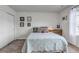 Comfortable bedroom featuring carpeted floors, light walls, and wall decor at 8255 S Vandriver Way, Aurora, CO 80016