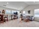 Bright bonus room featuring vaulted ceilings, multiple windows, and versatile living space at 8255 S Vandriver Way, Aurora, CO 80016