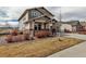 Well-maintained home with a cozy front porch and a manicured lawn on a sunny day at 8255 S Vandriver Way, Aurora, CO 80016