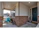 Inviting covered front porch with decorative stone accents and a cozy seating area at 8255 S Vandriver Way, Aurora, CO 80016