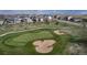 Beautiful aerial view of a golf course with lush green fairways and well-maintained sand traps surrounded by homes at 8255 S Vandriver Way, Aurora, CO 80016