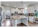 Well-lit kitchen featuring granite countertops, center island, and adjoining workstation at 8255 S Vandriver Way, Aurora, CO 80016