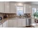 Bright kitchen with granite counters, tile backsplash, stainless steel appliances, and ample cabinet space at 8255 S Vandriver Way, Aurora, CO 80016