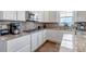 Updated kitchen featuring a gas range, stainless steel appliances, and granite countertops at 8255 S Vandriver Way, Aurora, CO 80016