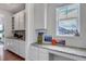 Kitchen nook featuring granite countertop, ample cabinet space, and a window with a view at 8255 S Vandriver Way, Aurora, CO 80016