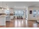 Bright living space featuring hardwood floors, white cabinets, and mountain views at 8255 S Vandriver Way, Aurora, CO 80016