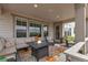 Relaxing covered patio features a comfortable seating area and a cozy fire pit with outdoor area view at 8255 S Vandriver Way, Aurora, CO 80016