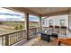 Covered patio with a fire table, sectional couch, and views of the golf course at 8255 S Vandriver Way, Aurora, CO 80016