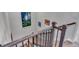 Carpeted staircase with stained wood and black wrought iron railings leads to the upper level at 8255 S Vandriver Way, Aurora, CO 80016