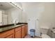This full bathroom features an expansive mirror, tile floors, and granite countertops at 9622 W Coco Cir # 203, Littleton, CO 80128