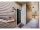 Condo entrance featuring unit number, exterior lighting, and a colorful welcome mat at 9622 W Coco Cir # 203, Littleton, CO 80128