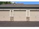Attached garages offer convenient parking with durable doors and stone accents at 9622 W Coco Cir # 203, Littleton, CO 80128