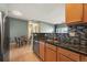 Well-appointed kitchen with granite countertops, mosaic backsplash, stainless appliances, and eat-in dining area at 9622 W Coco Cir # 203, Littleton, CO 80128
