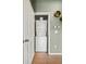 Convenient in-unit laundry closet with a stacked washer and dryer, maximizing space at 9622 W Coco Cir # 203, Littleton, CO 80128