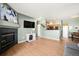 Inviting living room with fireplace, wood floors, and open access to kitchen perfect for hosting at 9622 W Coco Cir # 203, Littleton, CO 80128