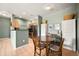 Open concept kitchen and dining area with wood floors and modern finishes for easy entertaining at 9622 W Coco Cir # 203, Littleton, CO 80128