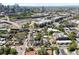 Bird's-eye view of the neighborhood showcasing homes and apartment buildings against a backdrop of the Denver skyline at 1718 W 33Rd Ave, Denver, CO 80211