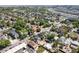 Wide aerial view of neighborhood with single Gathering homes, businesses, and downtown Denver in the background at 1718 W 33Rd Ave, Denver, CO 80211