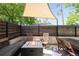 Outdoor patio seating area has a fire pit and shade awning at 1718 W 33Rd Ave, Denver, CO 80211