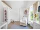 Bright Bedroom features hardwood floors, modern chair, and natural light from the window at 1718 W 33Rd Ave, Denver, CO 80211