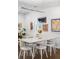 Bright dining room with white table and chairs, modern light fixture, and art-filled walls at 1718 W 33Rd Ave, Denver, CO 80211