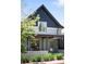 Charming two-story home with a covered porch and well-maintained landscaping at 1718 W 33Rd Ave, Denver, CO 80211