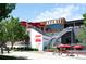 Street view of a vibrant restaurant featuring multi-level outdoor seating, red umbrellas, and stairs at 1718 W 33Rd Ave, Denver, CO 80211