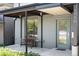 Inviting front porch with seating and a modern design, featuring a stylish door at 1718 W 33Rd Ave, Denver, CO 80211