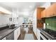 Bright kitchen featuring stainless steel appliances, dark countertops, and dining area with plenty of natural light at 1718 W 33Rd Ave, Denver, CO 80211