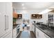 Modern kitchen features a view to the outdoor patio, brick accent wall, and updated cabinets at 1718 W 33Rd Ave, Denver, CO 80211