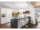 Contemporary kitchen with a large island, modern lighting, and bar stool seating at 1718 W 33Rd Ave, Denver, CO 80211