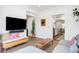 Spacious living room with a large TV, exposed brick wall, and contemporary furnishings at 1718 W 33Rd Ave, Denver, CO 80211