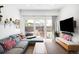 Comfortable living room with sliding glass doors leading to a patio and a mounted television at 1718 W 33Rd Ave, Denver, CO 80211