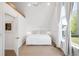 Bright bedroom with hardwood floors, large window with white curtains, and white walls at 1718 W 33Rd Ave, Denver, CO 80211