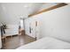 Bright main bedroom features hardwood floors, modern ceiling fan, and ample storage space at 1718 W 33Rd Ave, Denver, CO 80211