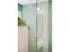 Updated shower with modern fixtures and unique green tile at 1718 W 33Rd Ave, Denver, CO 80211