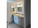 Bathroom with white vanity, sink, and framed mirrors, offering storage at 9725 E Harvard Ave # 346, Denver, CO 80231