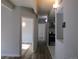Well-lit hallway featuring wood floors, leading to the kitchen and other rooms at 9725 E Harvard Ave # 346, Denver, CO 80231